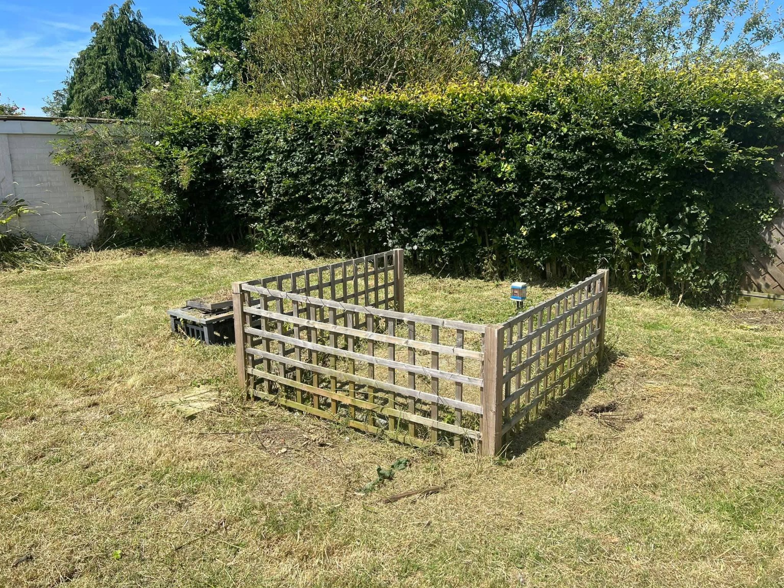 Cut lawn around the timber garden enclosure